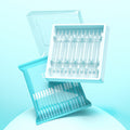 Silicone Ear Cleaning Sticks in clear silicone, shown in a white tray and translucent teal resealable pouch