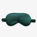 Simulated Silk Sleep Eye Mask in deep green with a smooth satin-like surface, contoured shape, and gathered elastic strap