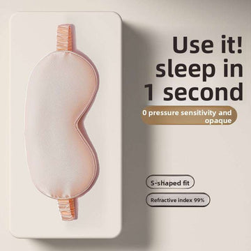 Simulated Silk Sleep Eye Mask in soft peach-pink fabric, with a contoured S-shaped fit and elastic straps