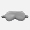 Simulated Silk Sleep Eye Mask in silver gray with a smooth, lightly padded surface, contoured shape and gathered elastic strap