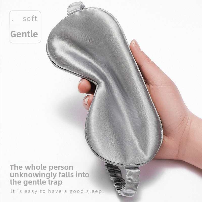 Simulated Silk Sleep Eye Mask in smooth silver-gray fabric, with a contoured shape and gathered elastic strap.