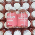 Skin Whitening Vitamins Gummies in pink-labeled clear bottles, showing orange gummies and 60-gummy supplement labels