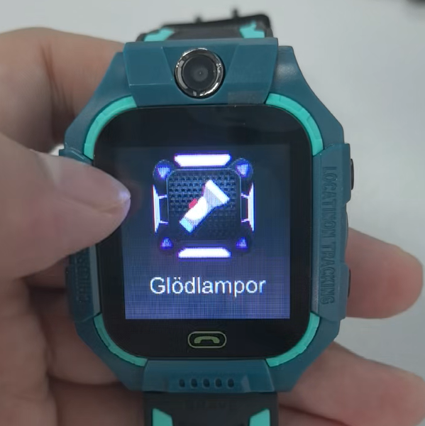 Smart Watch Phone with a dark teal silicone band, turquoise trim, square digital screen and a front-facing camera