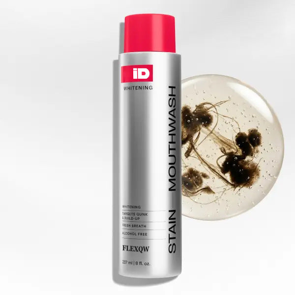 Stain Removing Mouthwash in a silver bottle with a bright red cap, white label, and bold vertical lettering.