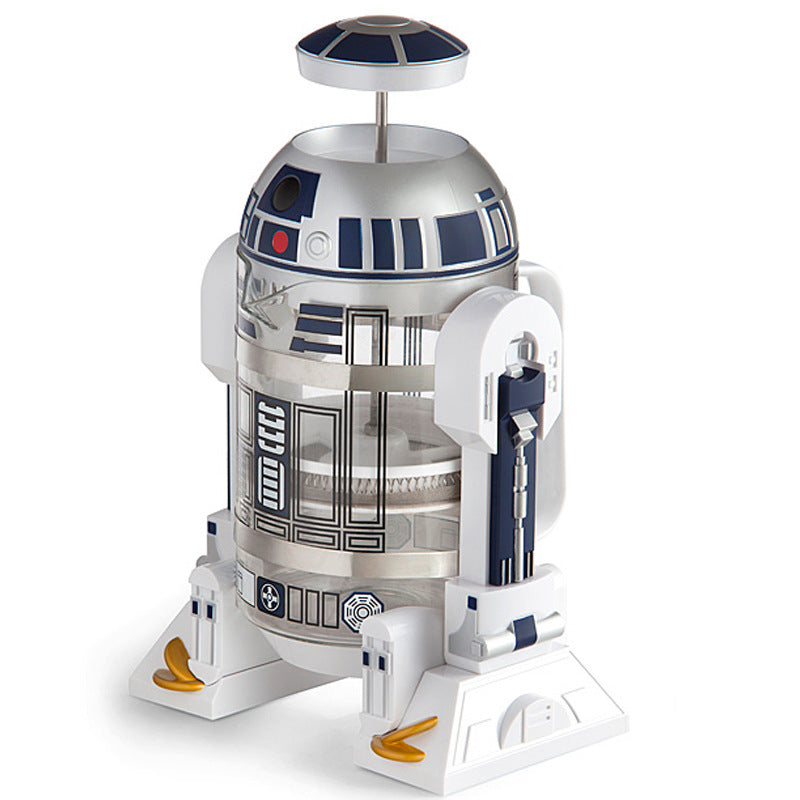 French press coffee maker shaped like a Star Wars R2D2 Robot, with a white plastic shell, silver and black panels, and glass carafe.