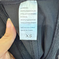 Steel-Boned Open Crotch Shapewear in black stretch fabric, shown with a white XS label listing nylon and elastane content
