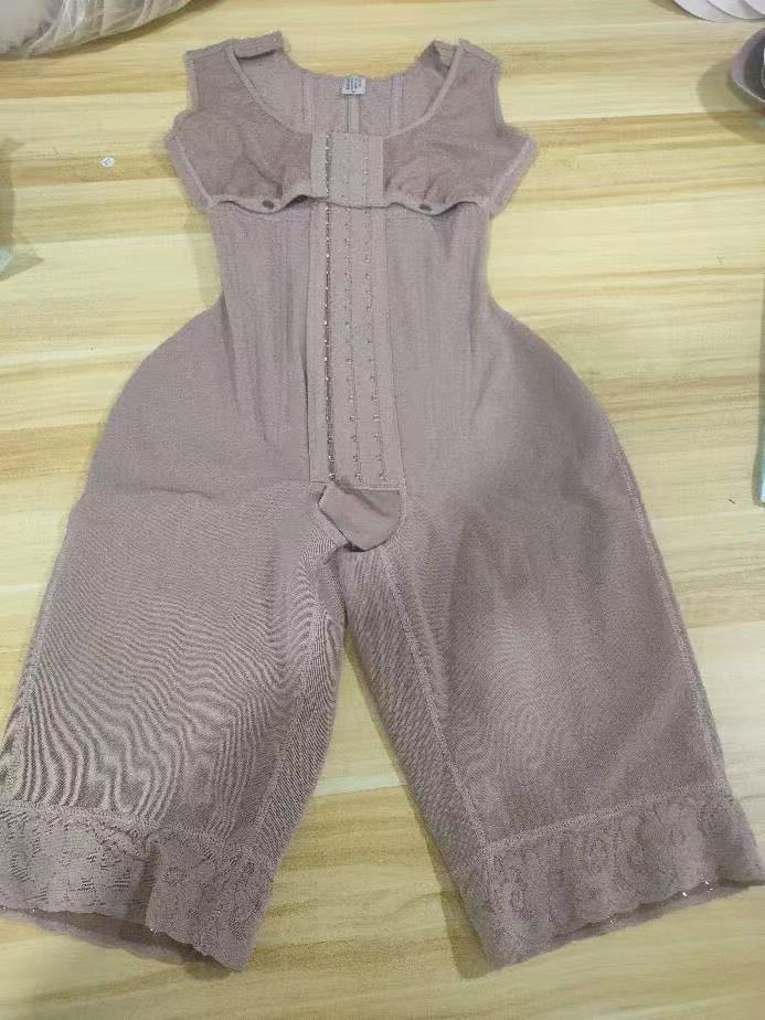 Steel-Boned Open Crotch Shapewear in muted mauve stretch fabric with a front closure, structured panels, and lace-trimmed legs