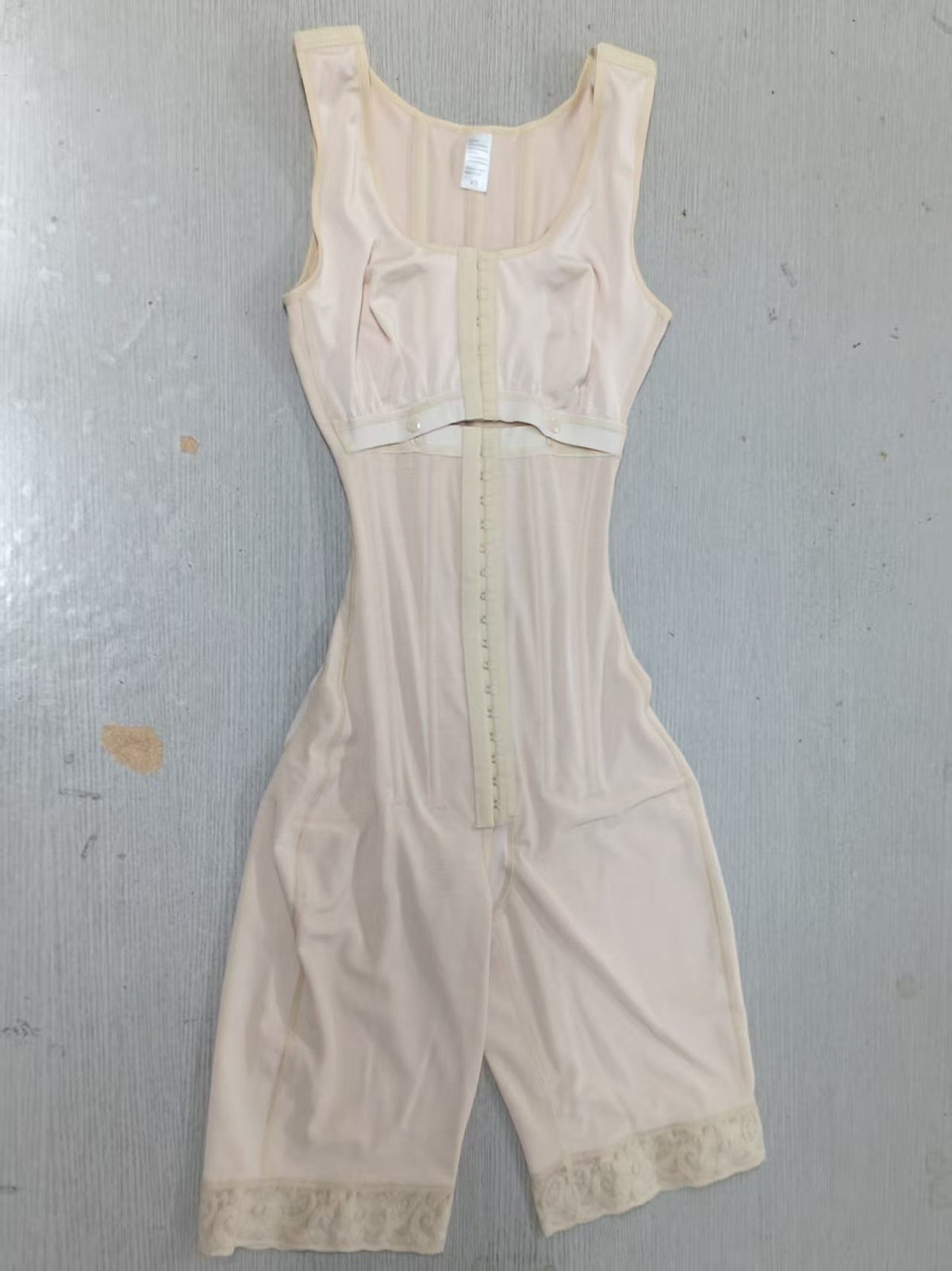 Steel-Boned Open Crotch Shapewear in nude beige stretch fabric, with a sleeveless bodice, front hook closure and lace-trimmed legs