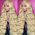Synthetic Fiber Wigs in pale blonde with a long, loose wavy texture and a sheer lace front hairline.