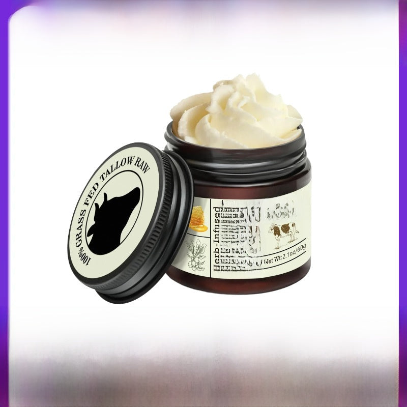 Tallow Honey Cream in an open dark amber jar, showing pale whipped balm and a cream label with a black animal silhouette