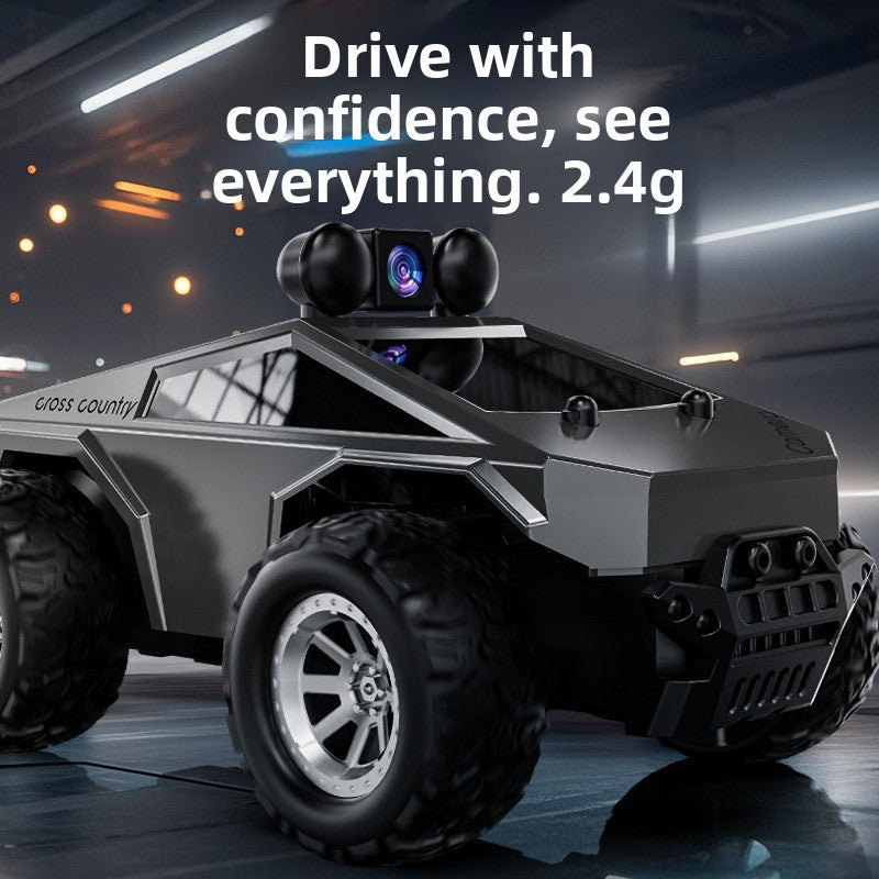 Tesla Toy Truck remote-control monster car in matte dark gray plastic, with oversized rugged tires and a roof-mounted camera.