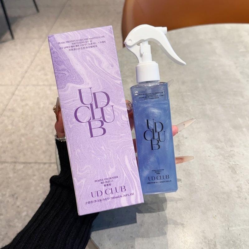 UD CLUB Pearl Protein smoothing hair care spray in a clear blue bottle with white trigger, paired with lavender box
