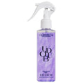 Hair smoothing spray UD CLUB Pearl Protein in a translucent lavender bottle with pearlescent shimmer and a white trigger nozzle