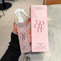 UD CLUB Pearl Protein hair care spray in a translucent pink bottle with white trigger, beside a matching pink box