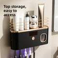 UV Sterilizing Toothbrush Holder in black with gold trim, top storage shelf, digital display, control button and toothbrushes.