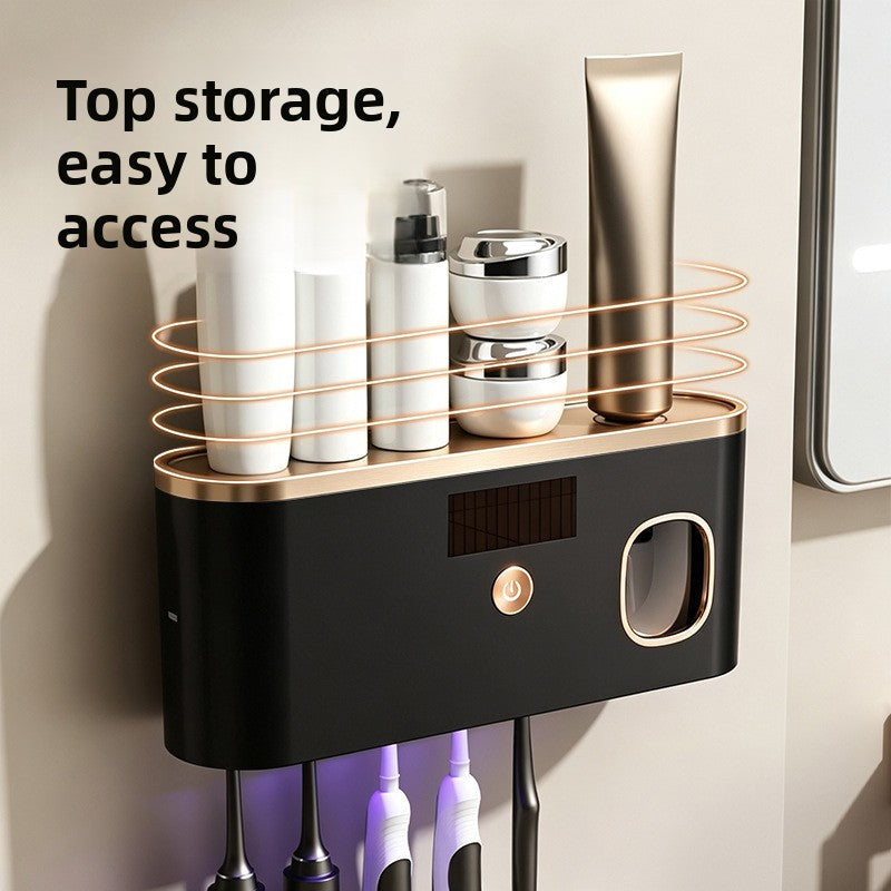 UV Sterilizing Toothbrush Holder in black with gold trim, top storage shelf, digital display, control button and toothbrushes.