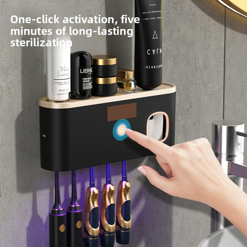 UV Sterilizing Toothbrush Holder in black plastic, wall-mounted with a touch button and purple UV glow beneath the shelf.