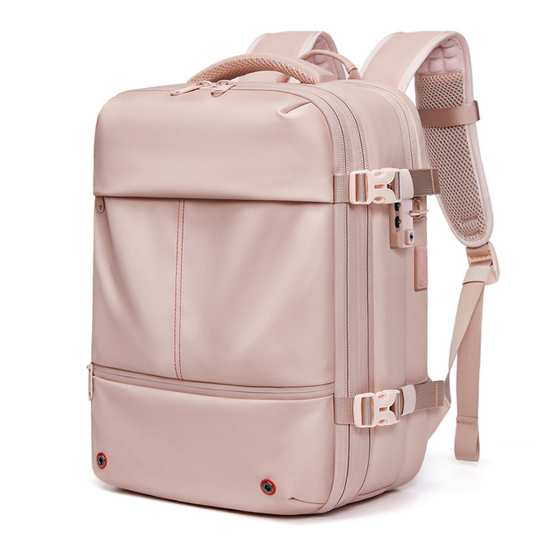 Vacuum Compression Travel Backpack in blush pink with smooth fabric, padded shoulder straps, compression zippers and buckles