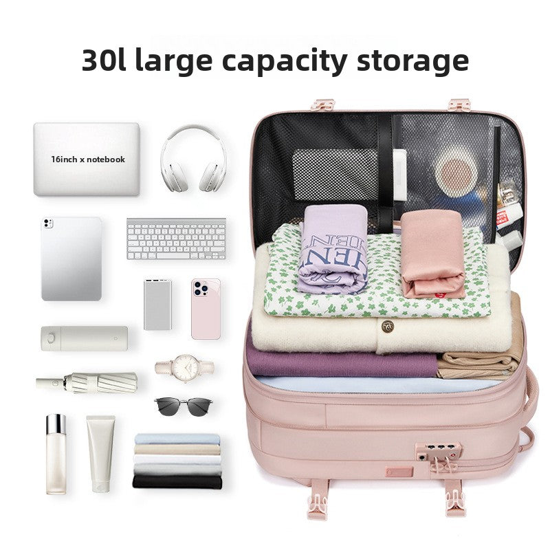Vacuum Compression Travel Backpack in blush pink opens to reveal folded clothing beneath a mesh organizer panel and compact travel essentials