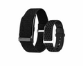 VIBE LOOP™ Air Fitness Wristband Monitor with two black straps, one woven fabric and one perforated silicone, beside the tracker
