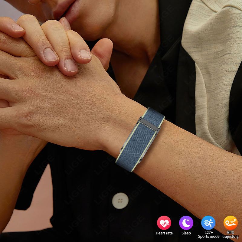 VIBE LOOP™ Air Fitness Wristband Monitor with a blue woven strap and rectangular silver-toned clasp worn on the wrist