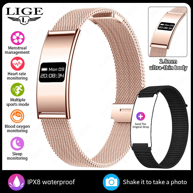 VIBE LOOP Ban smart wristband with a rose gold rectangular display, fine metal mesh band, and black replacement strap