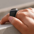 Smart fitness ring, VIBE LOOP Ban, with a glossy black face and silver-toned alloy band worn on a finger