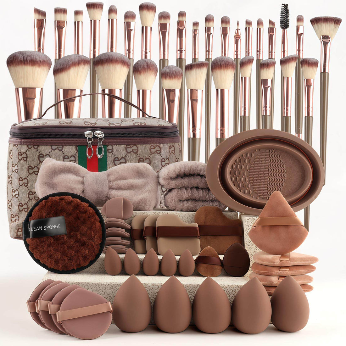 VIBE LOOP BANS Makeup brushes with brown synthetic bristles and rose-gold handles, paired with assorted puffs and sponges.