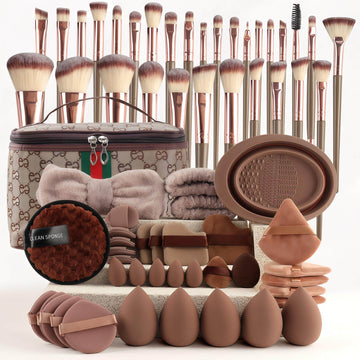 VIBE LOOP BANS Makeup brushes with brown synthetic bristles and rose-gold handles, paired with assorted puffs and sponges.