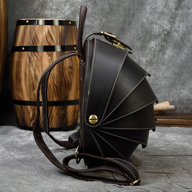 Vintage Genuine Leather backpack in dark brown with a smooth finish, fan-shaped beetle shell panels and contrast stitching