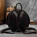 Vintage Genuine Leather backpack in dark brown oil-tanned hide, with a rounded beetle-inspired shape, stitched straps and top handle