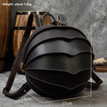 Backpack in dark brown genuine leather with a rounded beetle-inspired shape, layered curved panels and contrast stitching