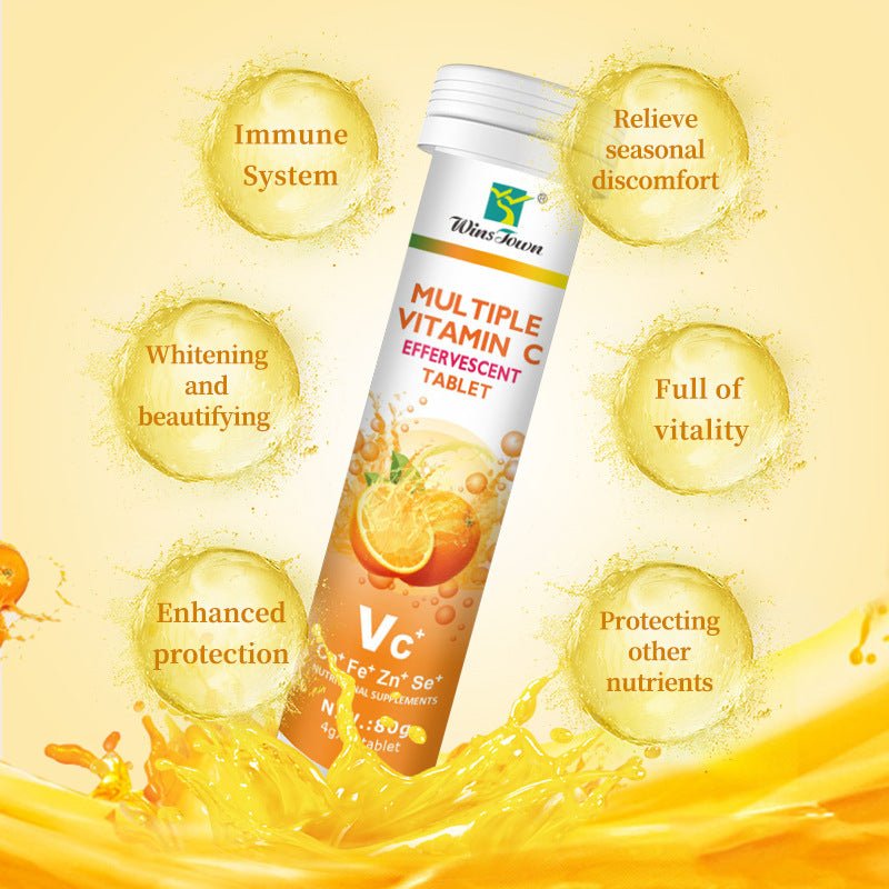 Vitamin C Tablets in a white cylindrical tube with orange fruit graphics, orange and white label, and screw cap.
