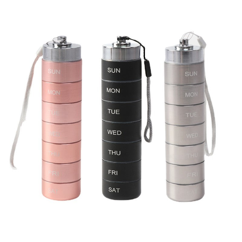 Waterproof Aluminum Alloy pill organizer in rose pink, black, and silver, with stacked daily compartments and wrist straps.