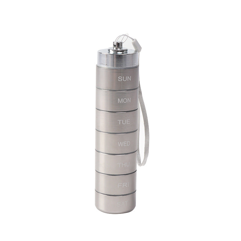 Waterproof Aluminum Alloy pill organizer in rose pink, black, and silver, with stacked daily compartments and wrist straps.